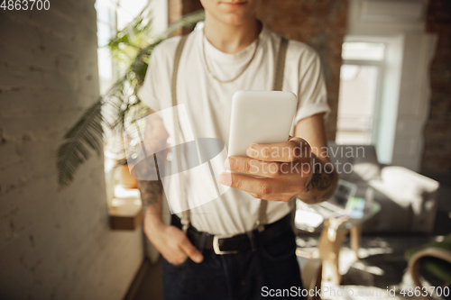 Image of Close up of male hands using smartphone, education and business concept