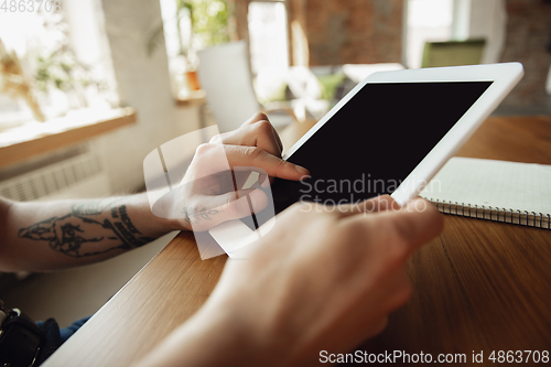 Image of Close up of male hands using tablet with blank screen, copyspace, education and business concept