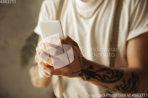 Image of Close up of male hands using smartphone, education and business concept