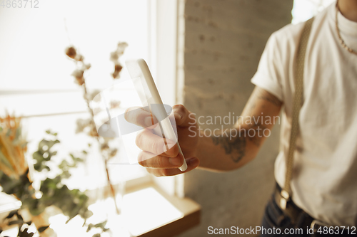 Image of Close up of male hands using smartphone, education and business concept