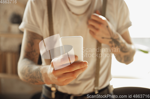 Image of Close up of male hands using smartphone, education and business concept