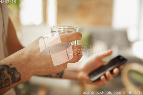 Image of Close up of male hands using smartphone, education and business concept