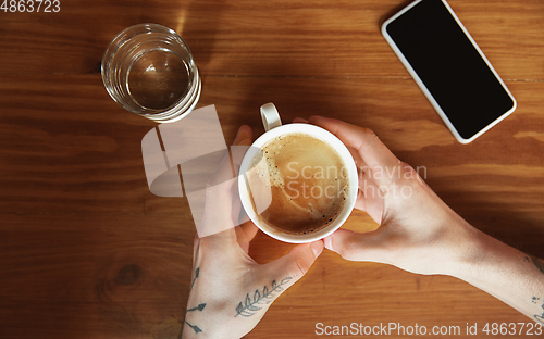 Image of Top view of male hands using smartphone with blank screen, copyspace, education and business concept, top view