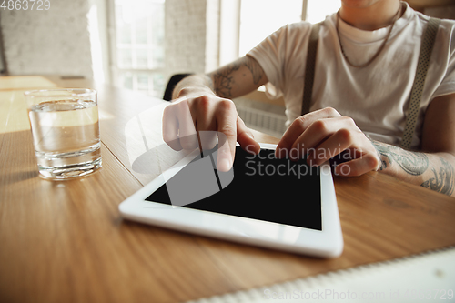 Image of Close up of male hands using tablet with blank screen, copyspace, education and business concept