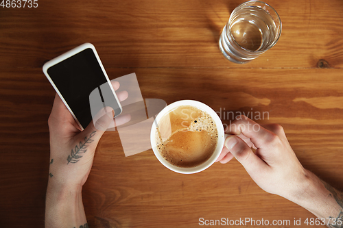 Image of Top view of male hands using smartphone with blank screen, copyspace, education and business concept, top view