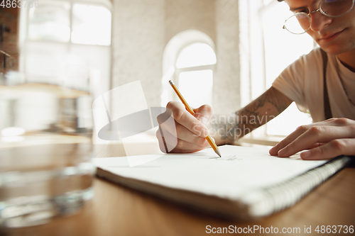 Image of Close up of male hands writing on an empty paper, education and business concept