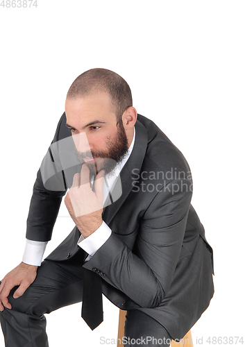 Image of Business man with hand on chin thinking