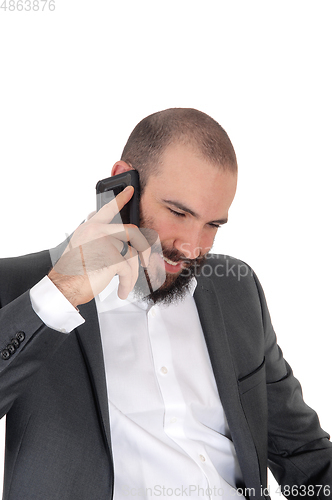 Image of Smiling man with beard on the cell phone