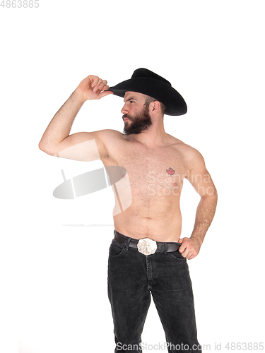 Image of Shirtless man with a cowboy hat, looking away