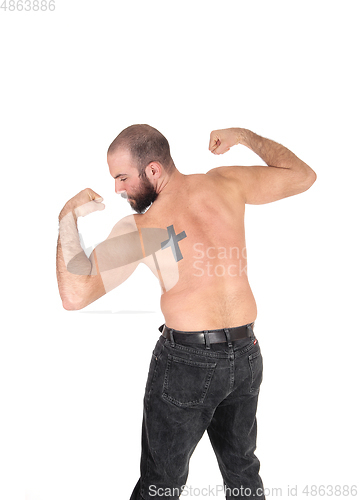 Image of Man standing from back shirtless with a tattoo