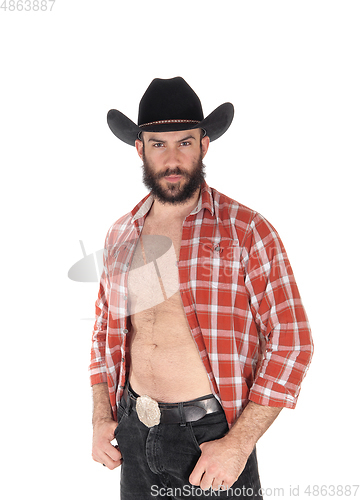 Image of Young man with open shirt and cowboy hat