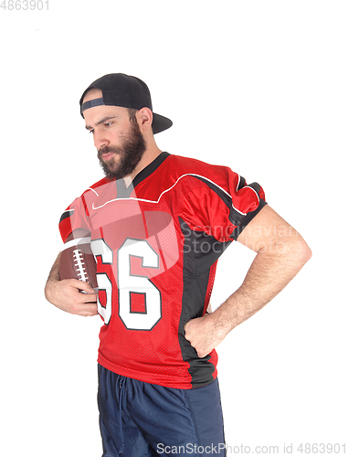 Image of Football player holding his ball and relaxing