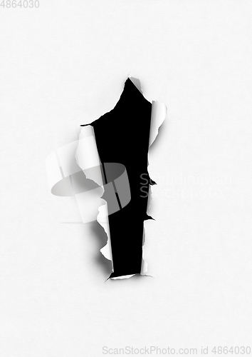 Image of White torn paper with black hole