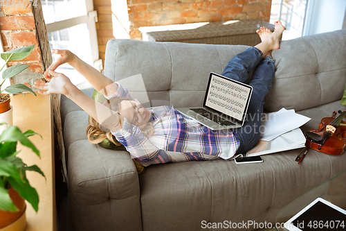 Image of Young woman studying at home during online courses or free information by herself