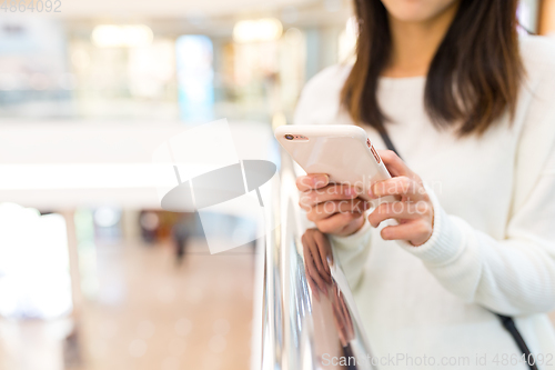 Image of Woman sending sms on cellphone