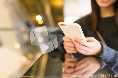 Image of Woman sending text message on mobile phone