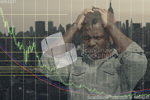 Image of Stressed man holding head with hands on abstract city background. Double exposure with graphs. Virus alert, coronavirus pandemic, crisis, unemployment