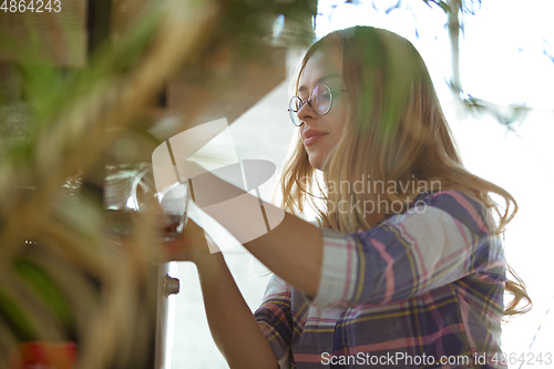 Image of Portrait of gorgeous woman at home, cozy atmosphere, calm