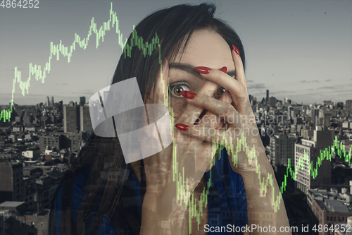 Image of Stressed woman holding head with hands on abstract city background. Double exposure with graphs. Virus alert, coronavirus pandemic, crisis, unemployment