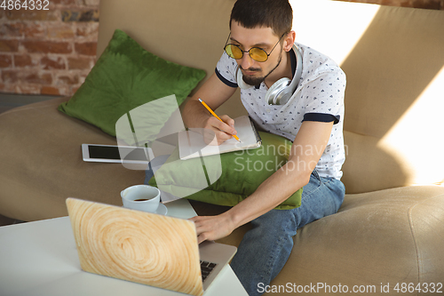 Image of Man working from home during coronavirus or COVID-19 quarantine, remote office concept