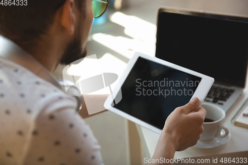 Image of Man working from home during coronavirus or COVID-19 quarantine, remote office concept