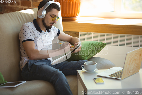 Image of Man working from home during coronavirus or COVID-19 quarantine, remote office concept
