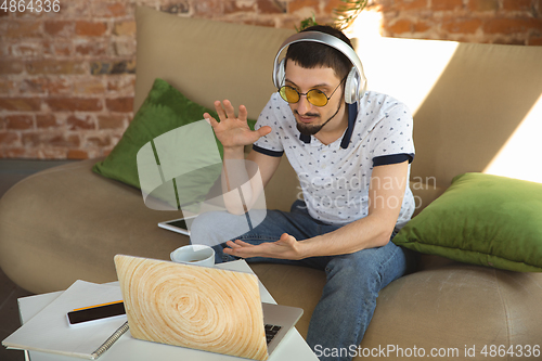 Image of Man working from home during coronavirus or COVID-19 quarantine, remote office concept