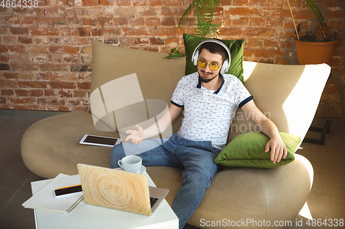 Image of Man working from home during coronavirus or COVID-19 quarantine, remote office concept