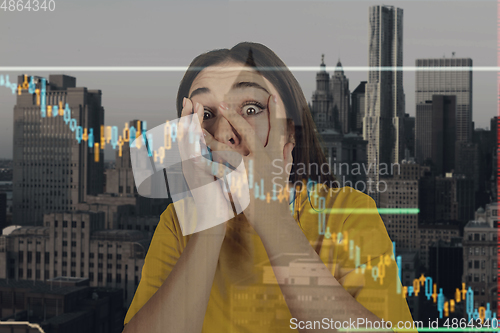 Image of Stressed woman holding head with hands on abstract city background. Double exposure with graphs. Virus alert, coronavirus pandemic, crisis, unemployment