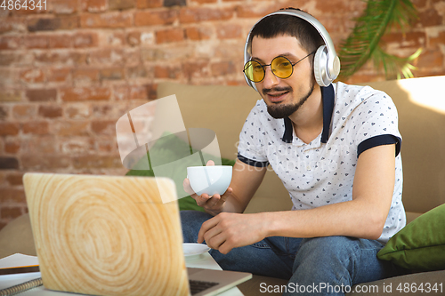 Image of Man working from home during coronavirus or COVID-19 quarantine, remote office concept