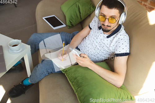 Image of Man working from home during coronavirus or COVID-19 quarantine, remote office concept