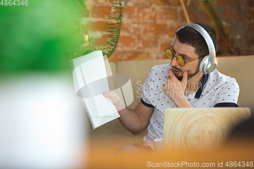 Image of Man working from home during coronavirus or COVID-19 quarantine, remote office concept