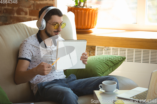 Image of Man working from home during coronavirus or COVID-19 quarantine, remote office concept