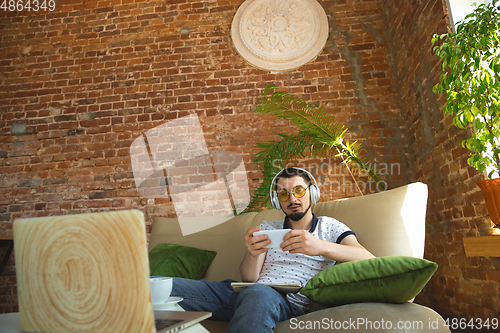 Image of Man working from home during coronavirus or COVID-19 quarantine, remote office concept