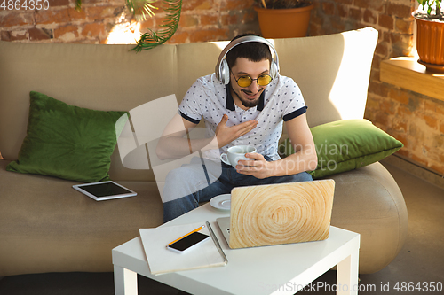 Image of Man working from home during coronavirus or COVID-19 quarantine, remote office concept