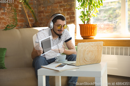 Image of Man working from home during coronavirus or COVID-19 quarantine, remote office concept