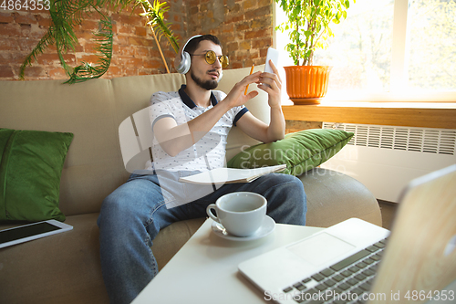 Image of Man working from home during coronavirus or COVID-19 quarantine, remote office concept