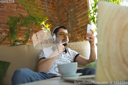 Image of Man working from home during coronavirus or COVID-19 quarantine, remote office concept