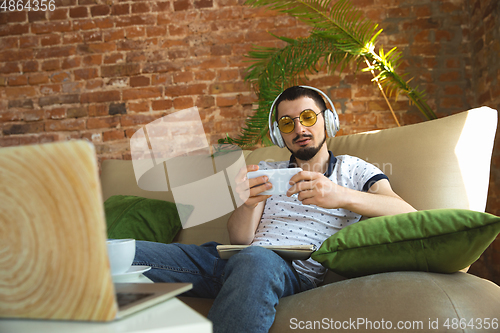 Image of Man working from home during coronavirus or COVID-19 quarantine, remote office concept