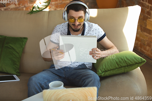 Image of Man working from home during coronavirus or COVID-19 quarantine, remote office concept