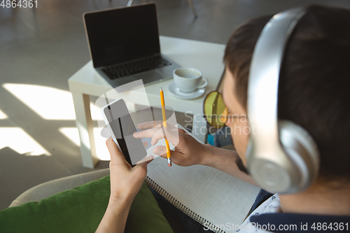 Image of Man working from home during coronavirus or COVID-19 quarantine, remote office concept