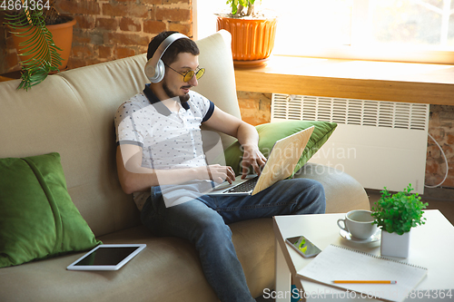 Image of Man working from home during coronavirus or COVID-19 quarantine, remote office concept