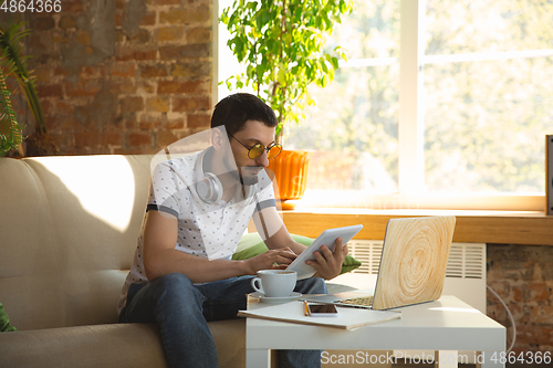 Image of Man working from home during coronavirus or COVID-19 quarantine, remote office concept