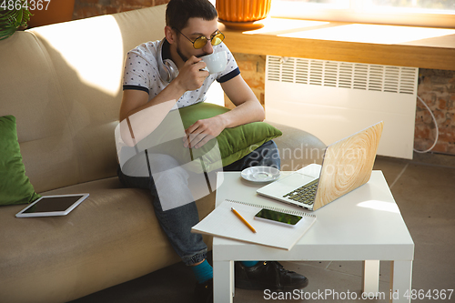 Image of Man working from home during coronavirus or COVID-19 quarantine, remote office concept