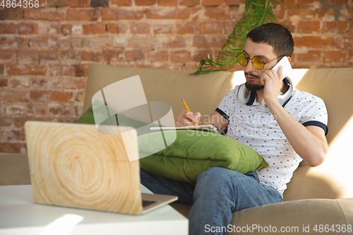 Image of Man working from home during coronavirus or COVID-19 quarantine, remote office concept