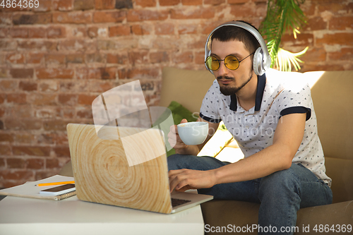 Image of Man working from home during coronavirus or COVID-19 quarantine, remote office concept