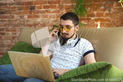 Image of Man working from home during coronavirus or COVID-19 quarantine, remote office concept