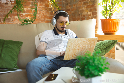 Image of Man working from home during coronavirus or COVID-19 quarantine, remote office concept