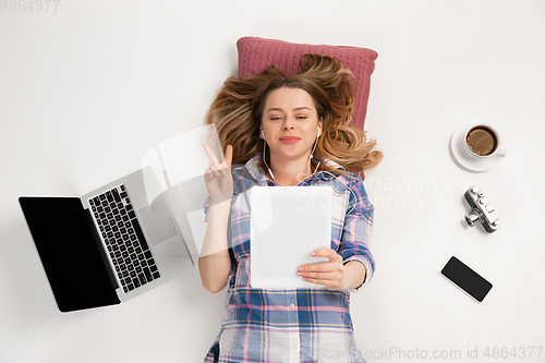 Image of Emotional caucasian woman using gadgets isolated on white studio background, technologies connecting people. Online meeting, selfie