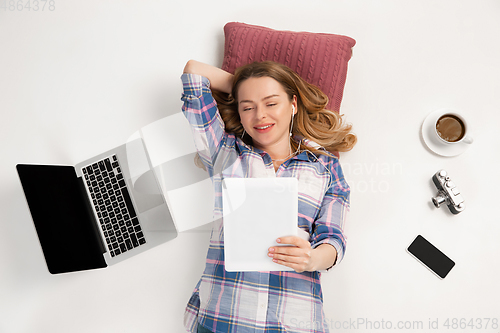 Image of Emotional caucasian woman using gadgets isolated on white studio background, technologies connecting people. Online meeting, selfie